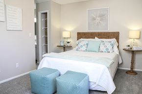 Mesa apartment for rent - a bedroom with a bed and two stools in front of it
