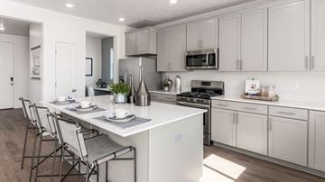 Heber City townhouse for rent - A modern kitchen with white cabinets and a central island.
