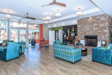 Mesa apartment for rent - a living room with blue couches and a brick fireplace