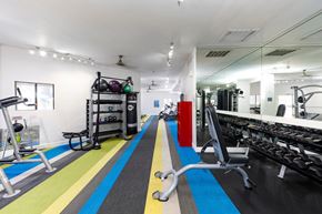 Phoenix apartment for rent - A gym with a variety of equipment including a treadmill, weights, and a bench press.
