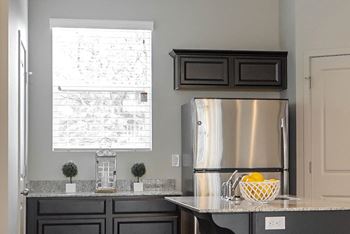 Kitchen with stainless refrigerator