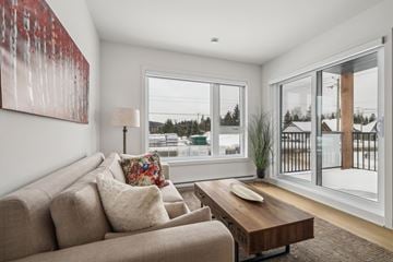 Mont-Tremblant apartment for rent - A living room with a couch, a coffee table, and a painting on the wall.