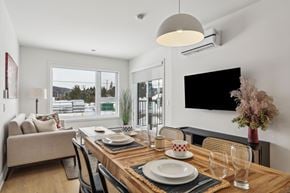 Mont-Tremblant apartment for rent - A modern dining room with a wooden table set for two.