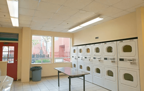 Oakland apartment for rent - A laundry room with a table and washing machines.
