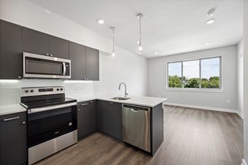 Philadelphia apartment for rent - A modern kitchen with dark brown cabinets and stainless steel appliances.