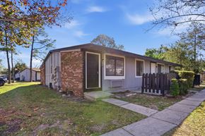 Orlando apartment for rent - A house with a brick wall and a wooden fence.