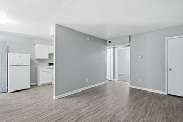 Memphis apartment for rent - A kitchen area with a white refrigerator and a grey wall.