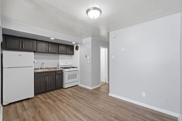 Philadelphia apartment for rent - A kitchen with white appliances and wooden floors.