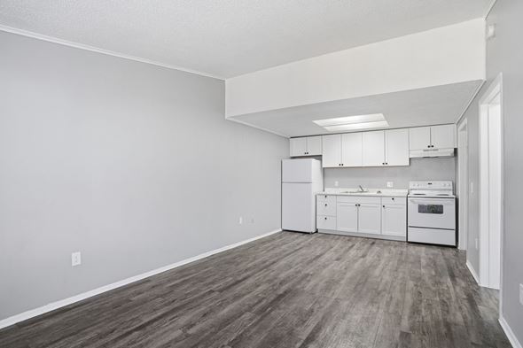 Orlando apartment for rent - A kitchen with white cabinets and a wood floor.