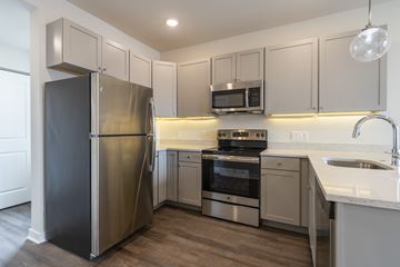 Philadelphia apartment for rent - A kitchen with a stainless steel refrigerator, oven, and microwave.