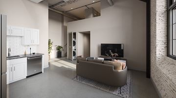 Philadelphia apartment for rent - A modern living room with a grey couch and a kitchen area with white cabinets.
