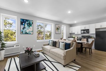 Philadelphia apartment for rent - A living room with a beige couch, a coffee table, and a painting on the wall.