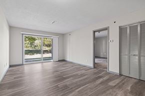 Carbondale apartment for rent - the living room of an apartment with a large window and a door to the yard