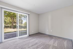 Carbondale apartment for rent - an empty living room with a large window and a door to the yard