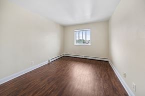 Atlantic City apartment for rent - an empty living room with wood flooring and a window