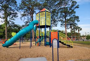 Jacksonville apartment for rent - A playground with a blue and yellow slide.