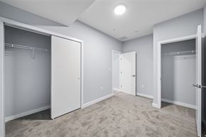 Philadelphia apartment for rent - A spacious room with carpeted floor and three open closet doors.