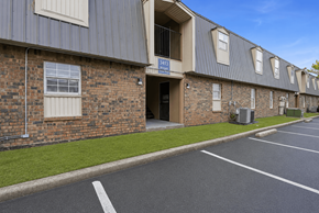 Memphis apartment for rent - A parking lot in front of a brick building with a blue sign that says "4310".