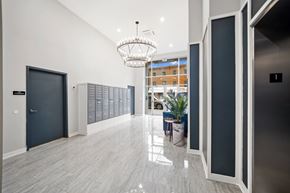 Philadelphia apartment for rent - A hallway with a chandelier and a bench.