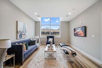 Philadelphia apartment for rent - A living room with a blue couch and a white rug.