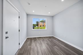 Philadelphia apartment for rent - A room with a white door and a window showing a building outside.