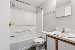 Columbus apartment for rent - A white bathroom with a toilet, sink, and bathtub.
