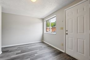 Columbus apartment for rent - A room with a white door and a window showing a view of a building outside.