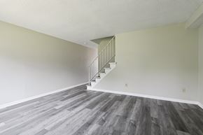 Columbus apartment for rent - A room with a staircase and wooden flooring.