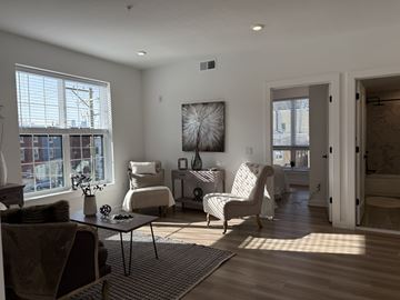 Philadelphia apartment for rent - A living room with a large window and a painting on the wall.