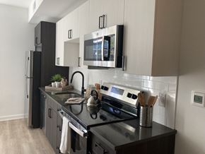 Philadelphia apartment for rent - Front Street Lofts Philadelphia PA apartments modern kitchen with stainless steel appliances, subway tile backsplash, and quartz countertops