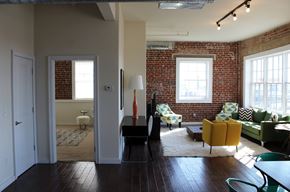 Philadelphia apartment for rent - A living room with a brick wall and wooden floors.