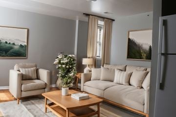 Philadelphia apartment for rent - A living room with a couch, chair, and a painting on the wall.