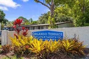 Orlando apartment for rent - A sign for Orlando Terrace Apartments stands in front of a building.