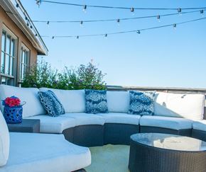 Philadelphia apartment for rent - A patio with a white couch and a round table.
