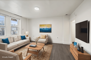 Philadelphia apartment for rent - A living room with a couch, a coffee table, and a painting on the wall.