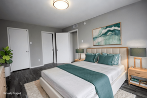 Dallas apartment for rent - A bedroom with a large bed and a painting on the wall.