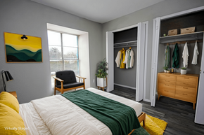 Dallas apartment for rent - A bedroom with a bed, chair, and wardrobe.