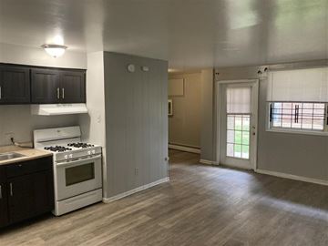 Philadelphia apartment for rent - A kitchen with a white stove and black cabinets.