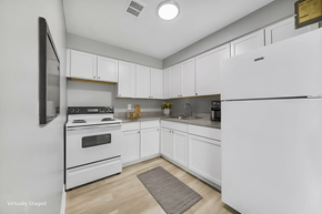 Cleveland apartment for rent - A kitchen with white appliances and cabinets.
