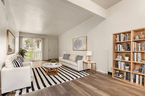Saint Louis apartment for rent - A living room with a white couch, a coffee table, and a bookshelf.