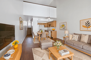 St. Louis apartment for rent - A living room with a couch, coffee table, and a dining table.
