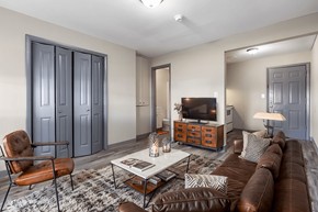 Carbondale apartment for rent - A living room with a brown leather couch, a coffee table, and a chair.