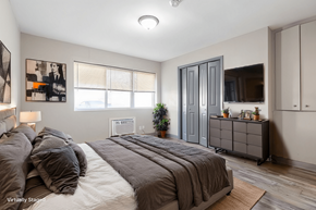 Carbondale apartment for rent - A bedroom with a large bed and a dresser.