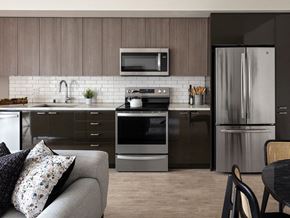 Seattle apartment for rent - a kitchen with stainless steel appliances and a couch