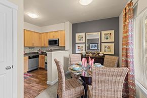 Gig Harbor apartment for rent - a dining room table with chairs and a kitchen in the background