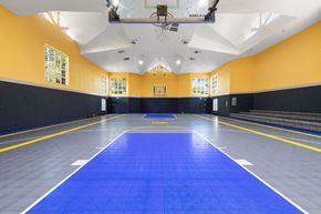 Bremerton apartment for rent - a large gym with a blue floor and a scoreboard