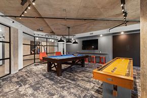 Kent apartment for rent - A pool table with a yellow cloth and a wooden table with a brown top.