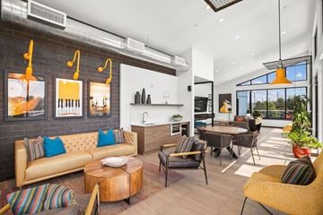 Kent apartment for rent - A modern living room with a yellow sofa and a wooden coffee table.