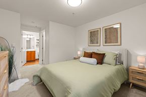Fife apartment for rent - A bedroom with a bed, nightstands, and two framed pictures on the wall.