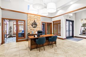 Maple Valley apartment for rent - a conference room with a wooden desk and chairs and a brick wall